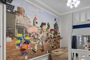 a bedroom with a wall mural of super heroes at Andy's Hideaway at Bahama Bay - Sage Vacations in Kissimmee +37 photos