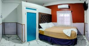a small bedroom with a bed in a room at Hotel Urban Center RM in San Marcos