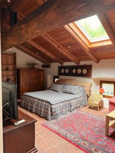 a bedroom with a bed and a flat screen tv at La casa Arancione in Boves