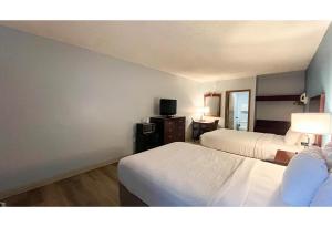 a hotel room with two beds and a television at Studio 6 Suites - Tiffin, OH in Tiffin +26 photos