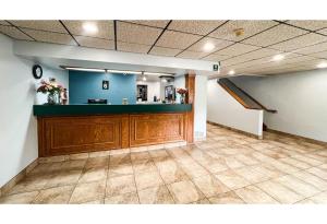 a lobby with a reception desk and a staircase at Studio 6 Suites - Tiffin, OH in Tiffin