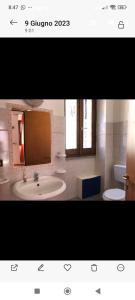 a bathroom with a sink and a toilet at Casa Arborea in Sennori