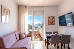 a living room with a couch and a table at Parid Apartments in Sarandë
