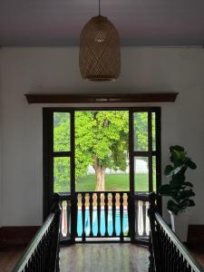 an open door to a porch with a tree outside at Casona El Remanso in Mariquita