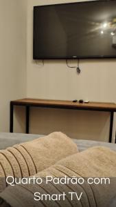 a flat screen tv on a wall in a room at Villa Container in the Wine Route in São Roque