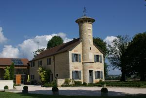 a building with a lighthouse on top of it at chambres d hotes ochene in Daix