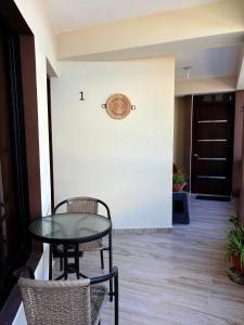 a table and chairs in a hallway with a door at Casa MIA in Cabarete