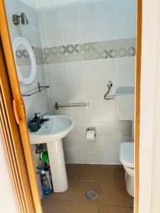 a bathroom with a sink and a toilet at La Mansarda di Terelle in Terelle
