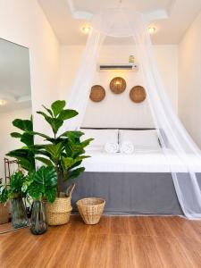 a bedroom with a bed with a mosquito net at Nami by Secret Place in Mae Haad