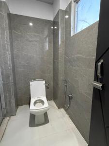 a bathroom with a toilet and a shower at Amrit bela in Haridwār +13 photos