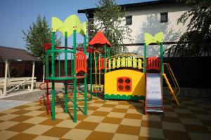 a playground with a slide and a playset at Сонячна in Solotvyno