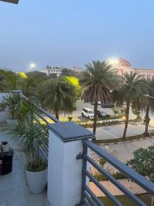 a view of a balcony with palm trees and a street at Amrit bela in Haridwār