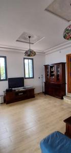an empty living room with wooden floors and windows at Blue ocean villa in Asilah