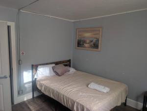 a bed in a bedroom with a picture on the wall at Bungalow Bleu in St. Petersburg +3 photos