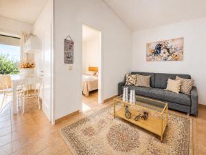 a living room with a couch and a table at Golden Tiara Apartment in Barbati