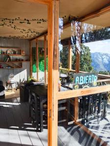 a house with a porch with a table and chairs at Cabañas Alma Serrana in San Jose del Pacifico