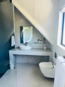 a bathroom with a sink and a toilet in a attic at Frank Road At The beach in St Francis Bay +1 photo