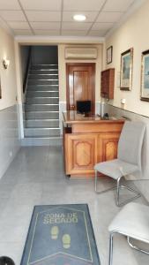 an office with a staircase and a rug on the floor at Hotel Vista Alegre in Torredonjimeno