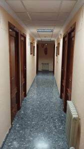 an empty hallway in an office building with a hallway at Hotel Vista Alegre in Torredonjimeno