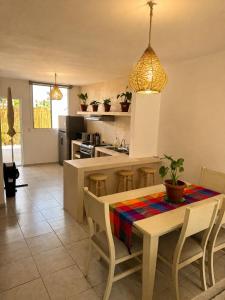 a kitchen and dining room with a table and chairs at Casa Coral in Puerto Morelos +8 photos