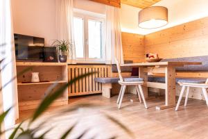 a dining room with a table and two chairs at Haus Lohengrin Ferienwohnung 2 in Siusi