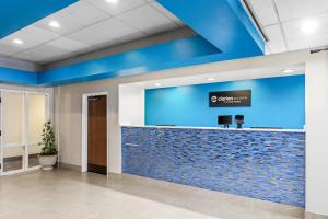 an office lobby with a blue accent wall at Clarion Pointe Jesup in Jesup +31 photos