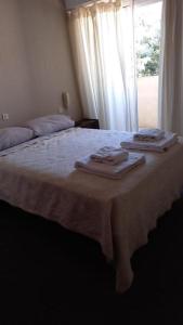 ein Schlafzimmer mit einem großen Bett, auf dem Handtücher liegen in der Unterkunft Bahia Ourense Hotel in San Clemente del Tuyú + 5 Fotos