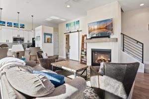 a living room with couches and a fireplace at Downtown WP Corner Loft 24 I Hot Tub I Great Views I Bunk Beds I Activity Program in Winter Park +15 photos