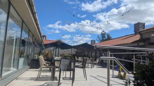 a patio with chairs and tables on a building at Seton Sands caravan close to Edinburgh in Port Seton