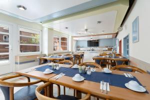 a dining room with wooden tables and chairs at Hotel an der Hörn in Kiel
