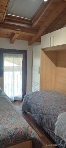 a bedroom with two beds and a window at Appartamento Orchidea Garda in Garda +69 photos