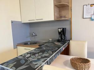 a kitchen with a counter top and a sink at nb APARTMENTS by the sea in Lumbarda