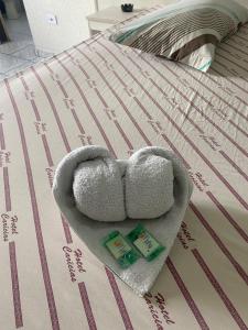 a teddy bear sitting on top of a bed at Hospedaria São Mateus in São Paulo