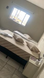 a loft bed with pillows on it in a room at Hospedaria São Mateus in São Paulo