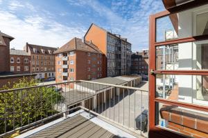 a balcony with a view of a city with buildings at Hotel an der Hörn in Kiel