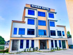 a hotel with a sign on the front of it at RIVANA HOTEL Goba in Dar es Salaam