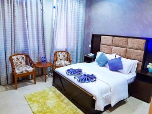 a bedroom with a bed and a table and chairs at RIVANA HOTEL Goba in Dar es Salaam +37 photos