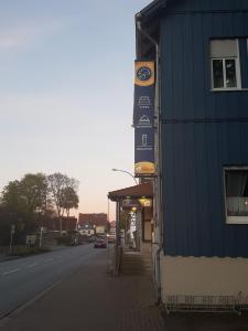 a sign on the side of a building next to a street at Esskastanie - Pension und Restaurant in Twiste