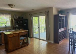 a kitchen with a table and a sliding glass door at High Cotton in Leesburg