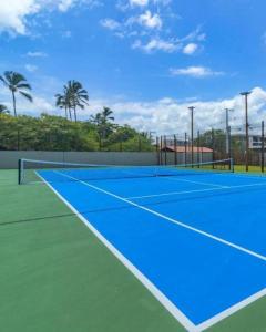 a tennis court with a blue tennis court at Cais Eco Residência in Ipojuca