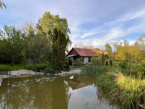 a gazebo next to a pond in a park at Chatka nad stawem in Radłów
