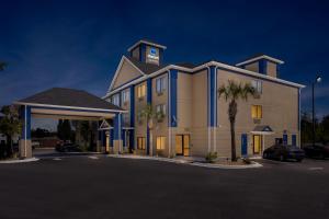 a large building with a clock tower on top of it at Clarion Pointe Jesup in Jesup