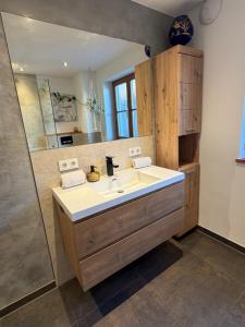 a bathroom with a sink and a mirror at Ferienwohnung Andreas in Holzkirchen +22 photos