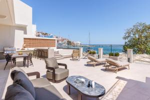 a patio with furniture and a view of the water at Cavo Mare Skopelos in Skopelos Town +47 photos