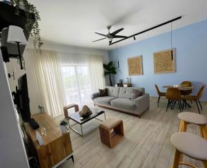 a living room with a couch and a table at Private Beach Community - White Sands Golf Resort - Modern 2BR Private Pool and Patio in Punta Cana