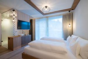 Voodi või voodid majutusasutuse Hotel Tofana toas