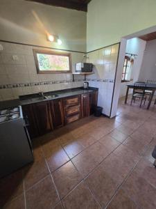 a kitchen with a sink and a counter top at El descanso in Veronica +6 photos