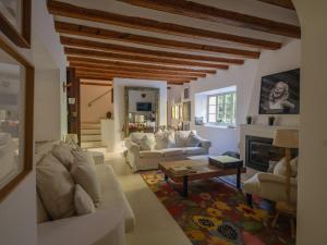 a living room with white furniture and a fireplace at Can 'Jeson in Deia