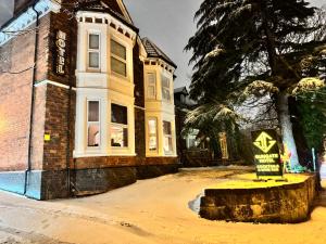 a house with a sign in front of it at The Gungate Hotel - Cocktails and Wine Bar in Tamworth