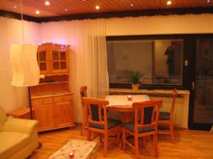 a kitchen with a table and chairs in a room at Ferienhaus Bundenthal in Bundenthal